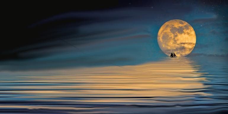 A full Moon at right, backlighting a distant sailing ship and reflecting off the ocean ripples toward the viewer.